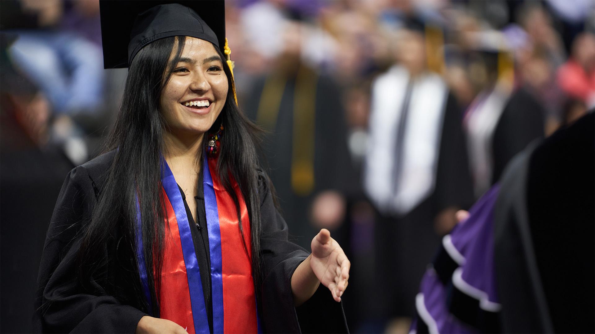 UE graduate shaking hand at commencement